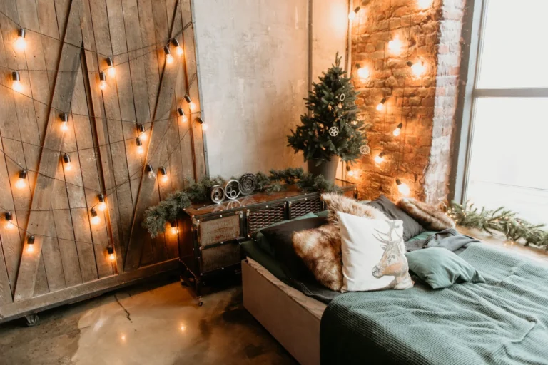 Rustic christmas bedroom decor ideas 2026 with a cozy bed, warm lights, and festive greenery