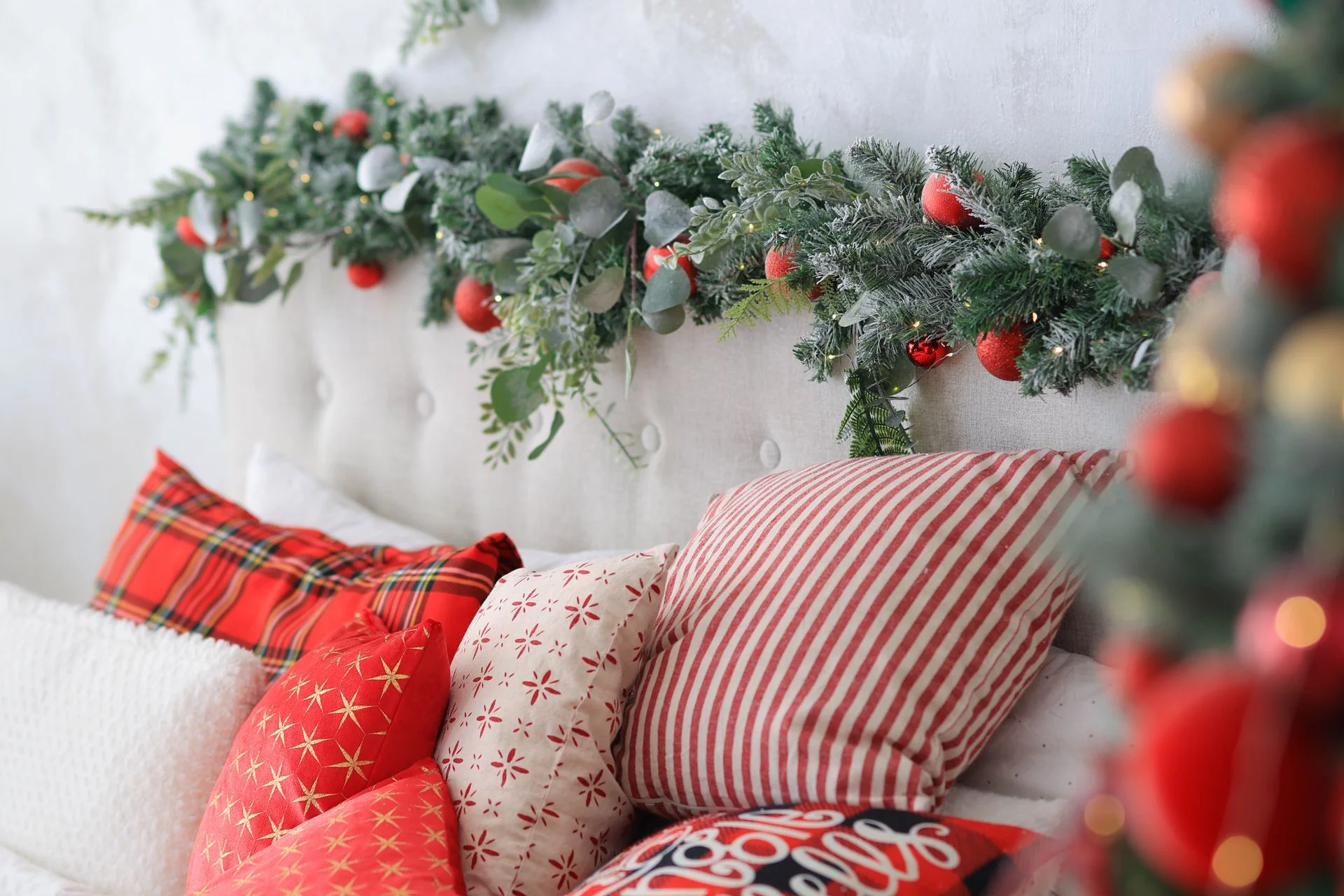 Festive rustic christmas bedroom with cozy pillows and holiday decorations on the bed